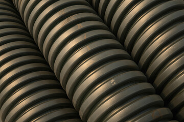 Abstract background of stacked, corrugated industrial pipes with a textured surface and metallic sheen, suggesting infrastructure and manufacturing.