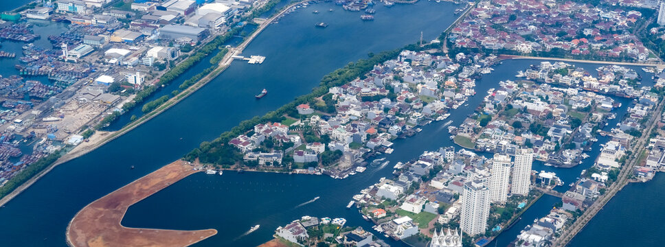Dense coastal sprawl of North Jakarta shows extreme urban density pressed against the sea, a vulnerable low-lying landscape facing rapid land subsidence and rising tidal risks.