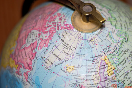 Greenland, with Denmark crossed out on globe map with America underneath