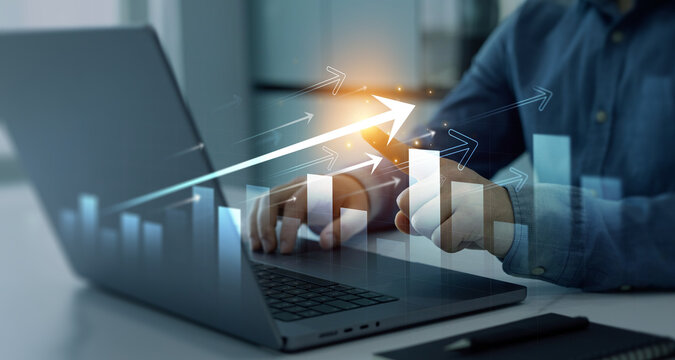 Businessman using laptop  analyzing sales data and financial report.Business growth graph chart. Financial marketing graph grow chart. Arrow up with graph corporate future growth plan.	