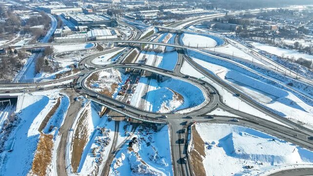Krakow, Poland. Grebalow highway and tramway interchange under construction in winter. Partially open for traffic. Last fragment of ring road around Krakow, Aerial time lapse. State in January 2026