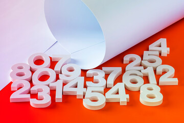 Sheets of paper and volumetric numbers on an orange background.