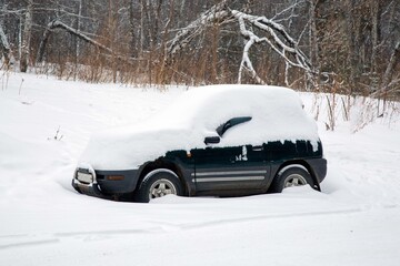 Snow-covered cars in the city in winter. Climate change, snow storm.