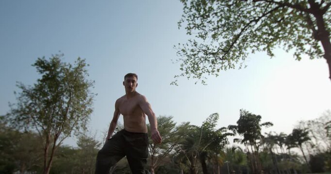 Capture the spirit of freedom in 1000fps slow motion. A young man enjoys his parkour hobby at sunset, performing a graceful corkscrew flip in a Bangkok park. Concept: lifestyle, freedom, joy, passion
