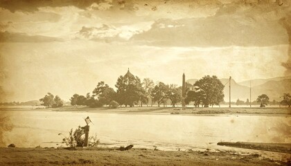 Sepia-toned vintage photograph of a pastoral riverside scene featuring distant architecture and rolling hills under a cloudy sky.