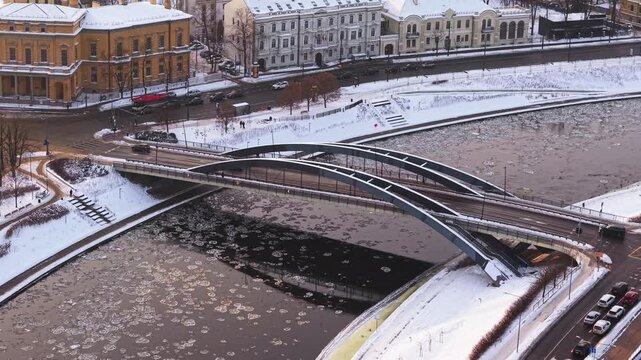 Aerial view of the Mindaugas Bridge crossing the river Neris, the city is covered in snow, Vilnius, Vilnius County, Lithuania.