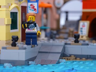 Obraz premium Tambov, Russian Federation - January 05, 2026 Lego man minifigure with camera standing on a dock