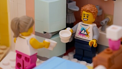 Obraz premium Tambov, Russian Federation - January 17, 2026 Lego man and woman minifigures with empty cups standing in a small kitchen.