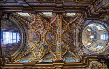 Fototapeta premium The Church of San Nicola alla Carita in Naples, Italy with ornate frescoed ceilings, marble columns in baroque style.Ornate Baroque ceiling frescoes by Francesco Solimena