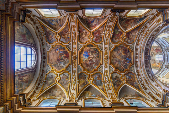 The Church of San Nicola alla Carita in Naples, Italy with ornate frescoed ceilings, marble columns in baroque style.Ornate Baroque ceiling frescoes by Francesco Solimena