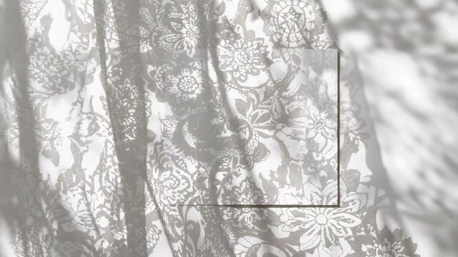 Shifting sunlight causing floral lace curtain swaying by window, moving panel, casting leaf shadows