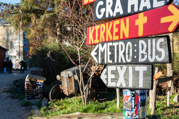 28 december 2025, Copenhagen, Denmark. A pole with brightly colored wooden signs pointing to the...
