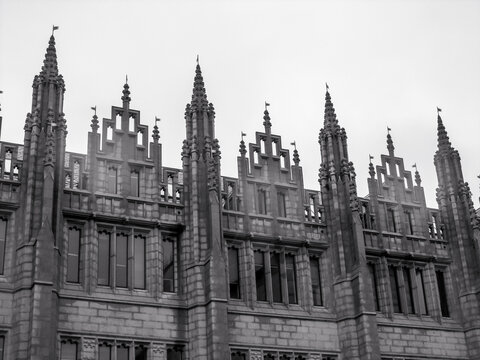 The detailed granite carved spires of Mariscal collage in the city of Aberdeen Scotland in black and white. 
