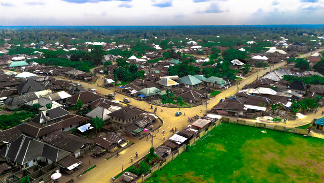 Aerial view of sun-drenched streets intersecting amidst the quaint buildings and lush greenery, creating a vibrant tapestry of life, Oduoha-Emuoha, Rivers, Nigeria.