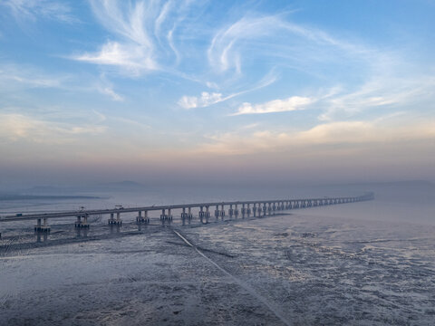 Aerial view of the Atal Setu bridge piercing through the morning mist, connecting Mumbai with a dance of light on the horizon, Mumbai, Maharashtra, India.