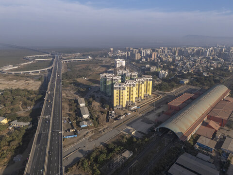 Aerial view of the Shri Atal Bihari Vajpayee Trans Harbour Link cutting a stark contrast against the urban sprawl, Mumbai, Maharashtra, India.
