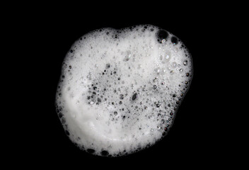 Fototapeta premium White soap foam bubble isolated on black background, flat cleaning texture with fresh hygiene concept, soft detergent lather surface for sanitation, cosmetic, skincare, and household design.