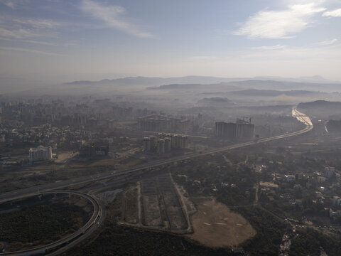 Aerial view of the Shri Atal Bihari Vajpayee Trans Harbour Link cutting through the cityscape, a modern marvel against the hazy horizon, Mumbai, Maharashtra, India.