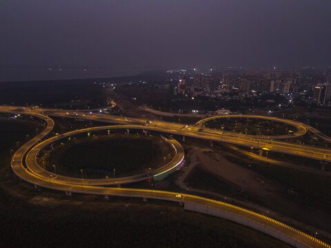 Aerial view of the luminous Shri Atal Bihari Vajpayee Trans Harbour Link gracefully curving through the night, a modern marvel, Mumbai, Maharashtra, India.