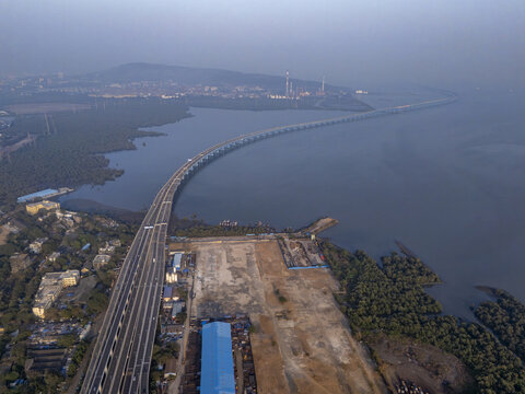 Aerial view of the Shri Atal Bihari Vajpayee Trans Harbour Link stretching across the water, a modern marvel piercing through the misty landscape, Mumbai, Maharashtra, India.