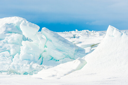 Icebergs near Qaanaaq village in Greenland reveal natural formations and glacial landscapes under clear blue sky