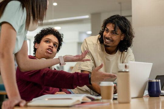 African American students studying and working in study area with laptop notebooks coffee bottle