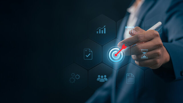 Goal setting and strategic focus using digital interface. businessman selecting target icon and strategy dashboard. strategic planning, performance tracking and digital business management for success
