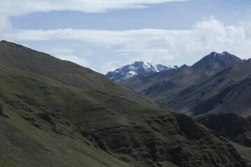 Fototapeta premium Snow-covered mountain next to Rainbow Mountain (Vinicunca) in Cusco, Peru, visible after extreme weather conditions.