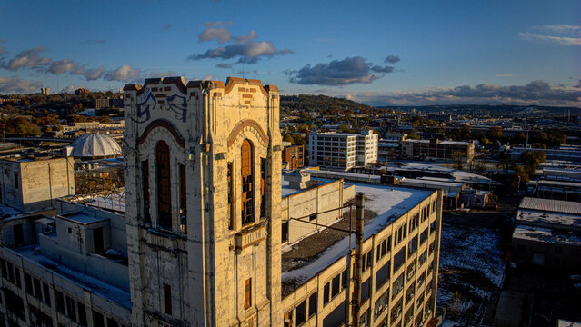 Aerial view of the striking tower casting long shadows across industrial rooftops, a dance of light and form in the urban expanse, Cincinnati, Ohio, United States.