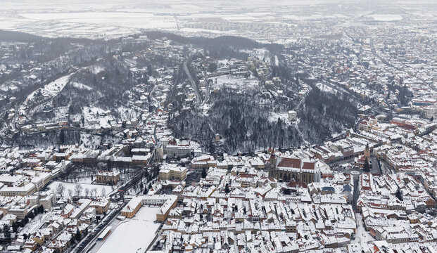 Brasov, Transylvania. Romania. Panoramic view of the old town and Council Square in the winter time,