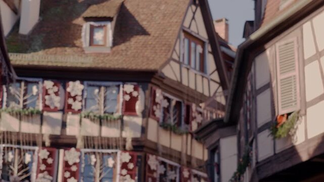 horizontal view over the roofs and facades of Colmar richly decorated with Christmas ornaments