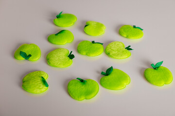 Green felt apple shapes arranged on light background