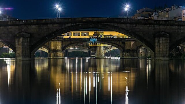 Twilight scene of Ponte Alla Carraia and Santa Trinita (Holy Trinity Bridge) day to night transition timelapse over River Arno with reflections on water after sunset. Florence, Tuscany, Italy