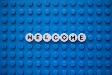 Obraz premium Tambov, Russian Federation - January 19, 2026 The word Welcome on a blue Lego baseplate. The scene is made out of Lego dots.