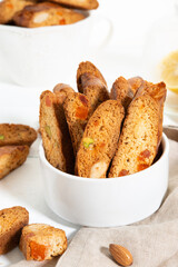 Italian cantucci cookies with nuts and candied fruits on a white background