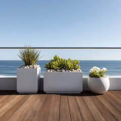 Obraz premium Modern white planters with green plants on wooden deck, ocean view, clear sky, peaceful outdoor setting