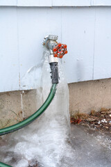 water leak from outdoor faucet frozen into ice