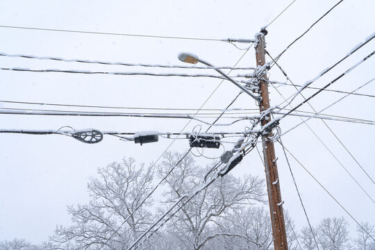 close up on telephone pole in snow storm