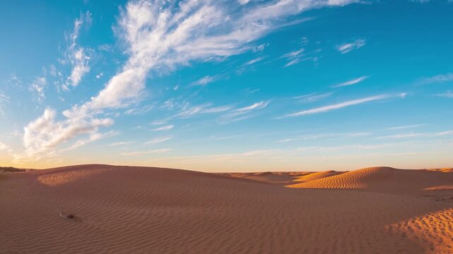 Timelapse: sunset over the desert near Ksar Ghilane, Tunisia, with red sand dunes and dramatic colorful clouds, conveying serenity and a timeless Sahara landscape ideal for travel and lifestyle themes