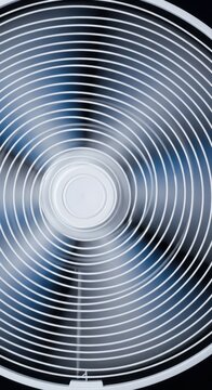 Electric fan blades spinning rapidly, circulating cool air and providing essential relief from uncomfortable, stifling summer heat, summer, domestic, warm