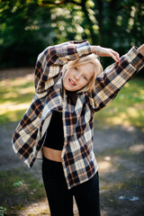 Young girl stretching arms outdoors in park