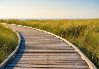 Weathered wooden planks form an elevated walkway winding through coastal dune grasses, highlighting sustainable outdoor travel, nature, trail, beach