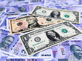 Fototapeta premium USD to INR currency exchange rate concept. Indian currency bank note and American dollar closeup shot