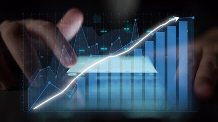 A close-up of hands interacting with a digital interface showcasing financial graphs and data, reflecting the influence of technology on business growth and analytics. Copula