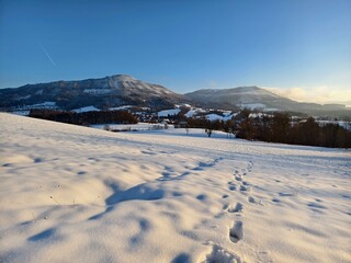 snowy landscape with field and hill