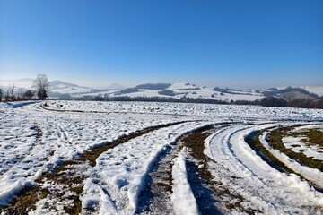 winter landscape with wheel tracks in the snow