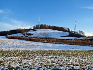 field and hill partially covered with snow