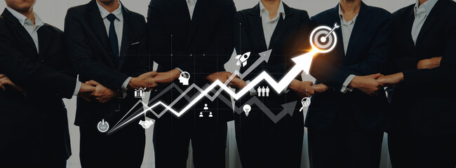 A professional business team stands together with their arms crossed, showcasing a growing graph symbolizing success, collaboration, and corporate achievement. Trope
