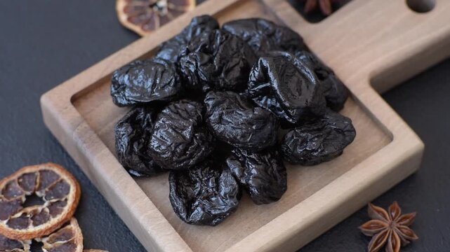 Sweet dried plums or prunes, organic dehydrated fruit for dietary nutrition. Prunes or dried plums as a food background for your design