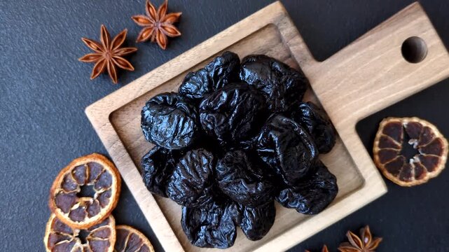 Sweet dried plums or prunes, organic dehydrated fruit for dietary nutrition. Prunes or dried plums as a food background for your design